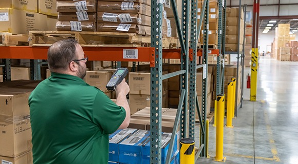 A warehouse worker scanning a box