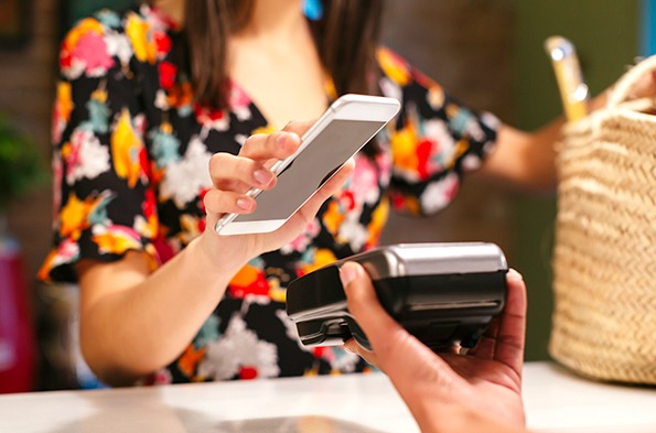 Customer using a mobile phone at a checkout