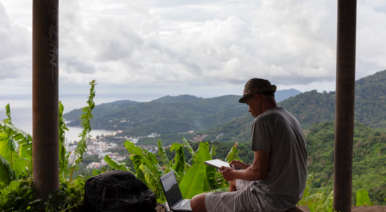 Man working on a laptop in the jungle