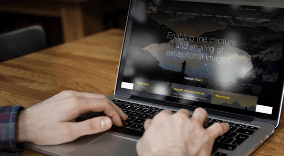 Person viewing the“The team all agreed EdgeConnect was much better in terms of SD-WAN management, ease of deployment, and supporting our cloud strategy,” Skinner says. Vitec website on a laptop