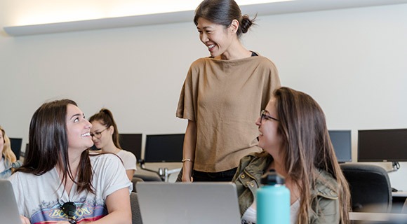 Students interacting with a teacher in the classroom
