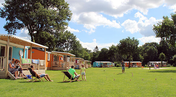 Guests enjoying lawn games while also using wireless devices at a Molecaten park