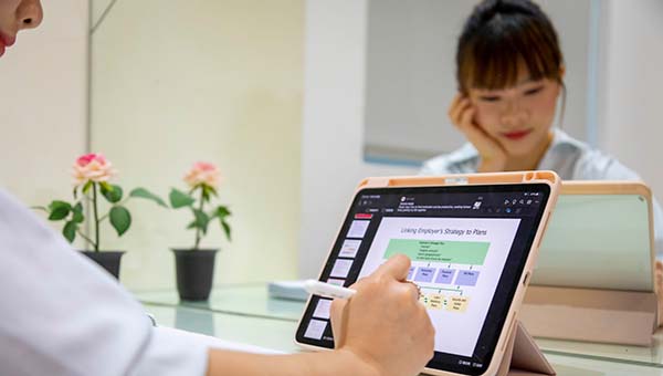Student working on a tablet at her dorm room