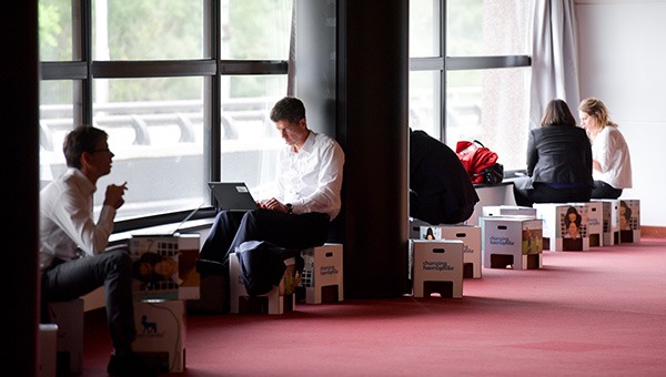 Users working on mobile devices during a business event