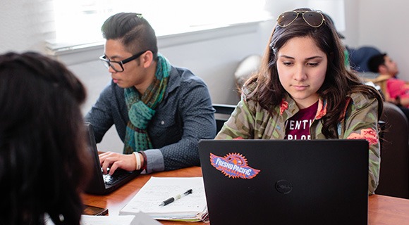 Students studying at desks together.