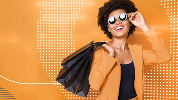 a woman wearing sunglasses and carrying shopping bags