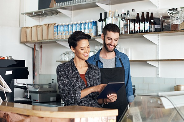 Small business owners setting up network on a tablet